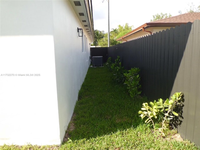 view of yard featuring central air condition unit