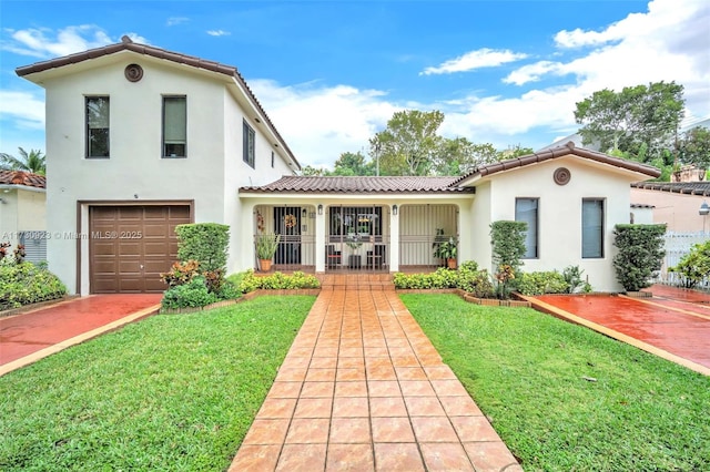 mediterranean / spanish home featuring a garage, a porch, and a front yard