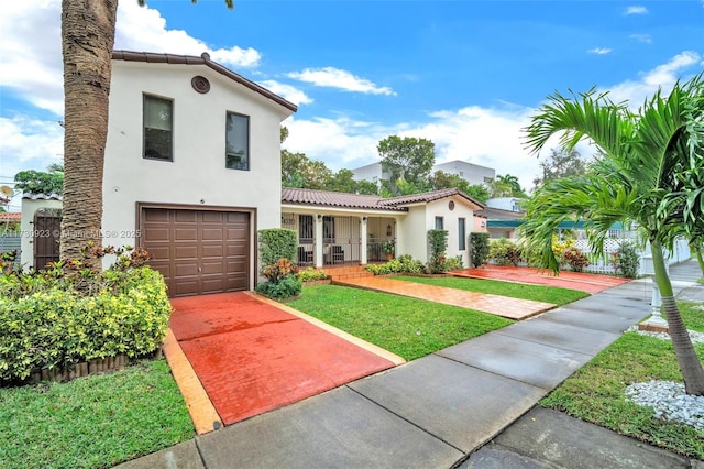 mediterranean / spanish-style house with a garage and a front lawn