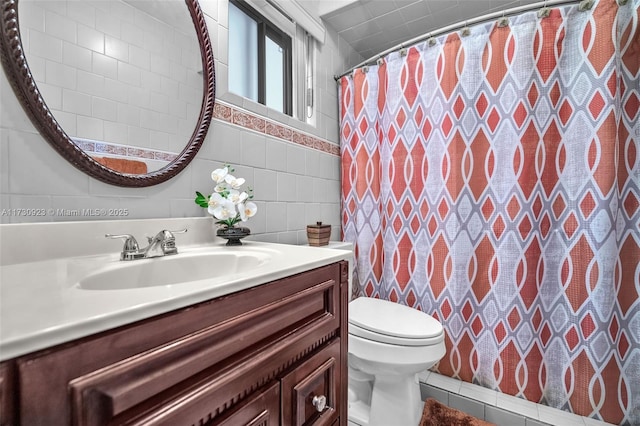 bathroom with tile patterned floors, toilet, tile walls, vanity, and a shower with shower curtain