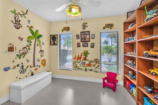 interior space featuring ceiling fan and a textured ceiling