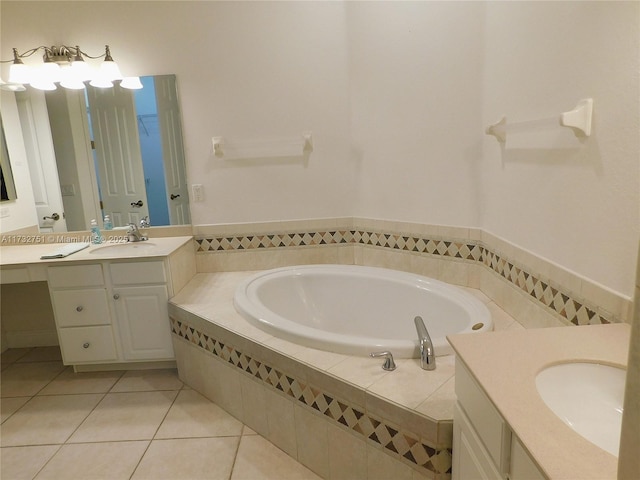 bathroom with tile patterned flooring, vanity, and tiled tub