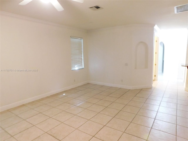 unfurnished room featuring ornamental molding, ceiling fan, and light tile patterned flooring