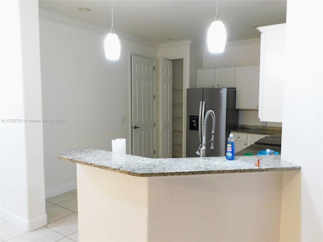 kitchen featuring white cabinetry, stainless steel fridge, kitchen peninsula, and decorative light fixtures