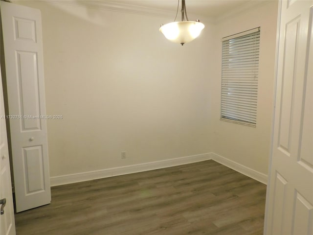 empty room with dark wood-type flooring and ornamental molding