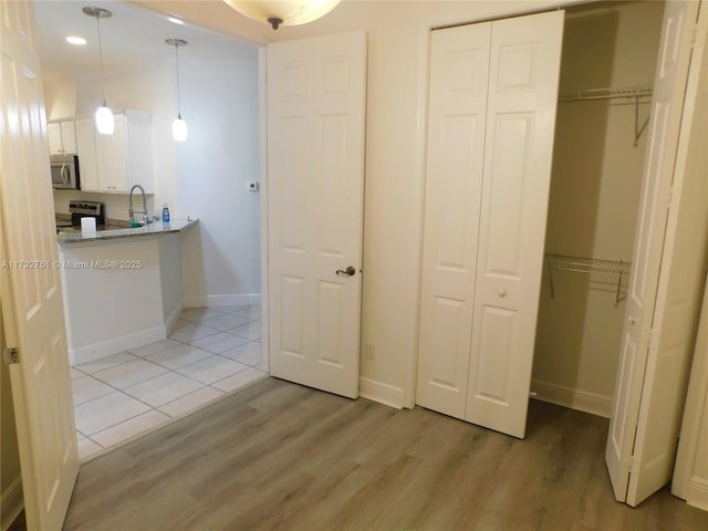 interior space featuring sink and light wood-type flooring