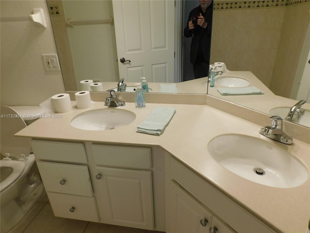 bathroom with vanity, tile patterned floors, and toilet