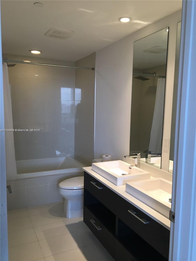 full bathroom featuring vanity, toilet, tile patterned floors, and shower / bath combo with shower curtain