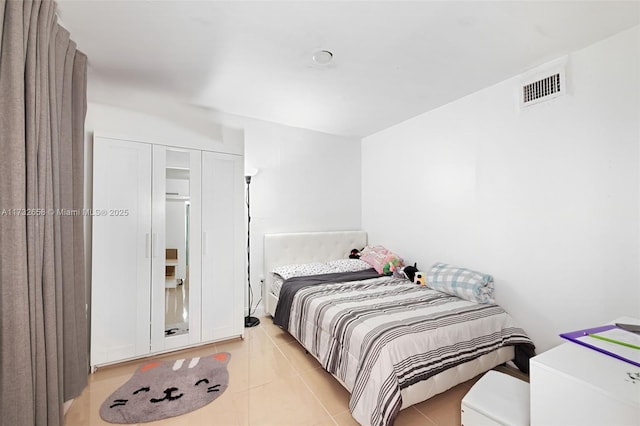 bedroom with light tile patterned floors