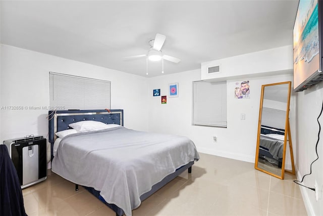 tiled bedroom featuring ceiling fan