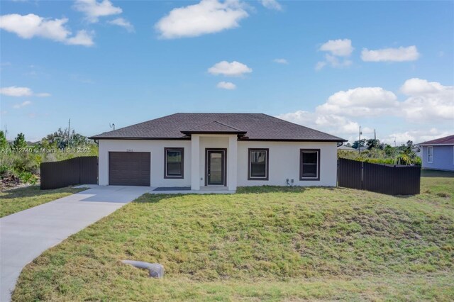 prairie-style house featuring a garage and a front yard