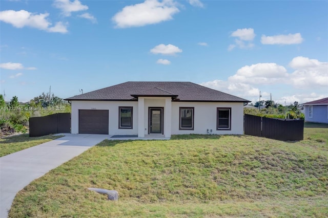 view of front of home with a garage and a front yard