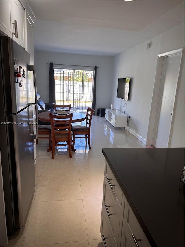 kitchen with stainless steel refrigerator and light tile patterned flooring