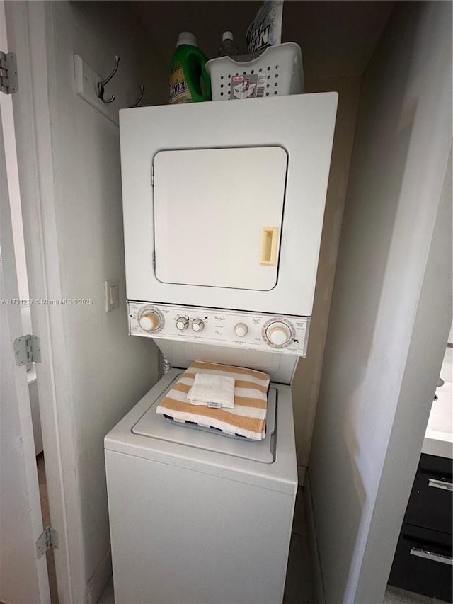 washroom featuring stacked washer / dryer