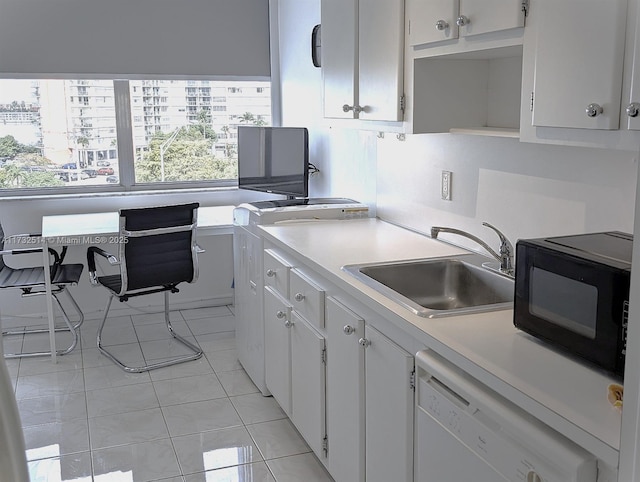 kitchen featuring white cabinetry, sink, white dishwasher, and light tile patterned flooring