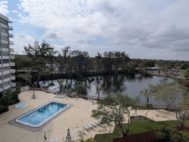 view of pool with a water view and a patio area