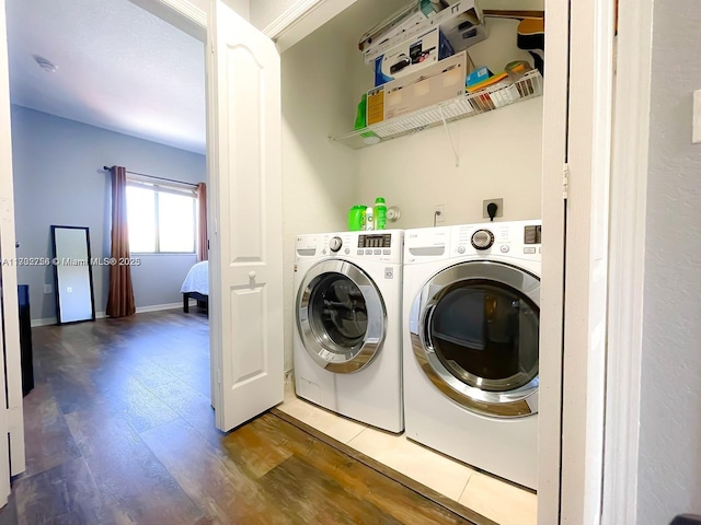 laundry area with washer and dryer and dark hardwood / wood-style floors