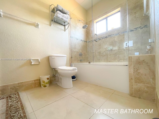 bathroom featuring tile patterned floors, shower / bath combination with glass door, and toilet