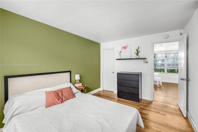 bedroom with hardwood / wood-style floors