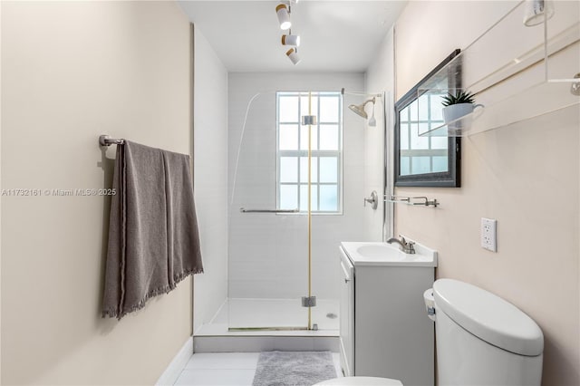 bathroom with vanity, toilet, tile patterned flooring, and a shower with door