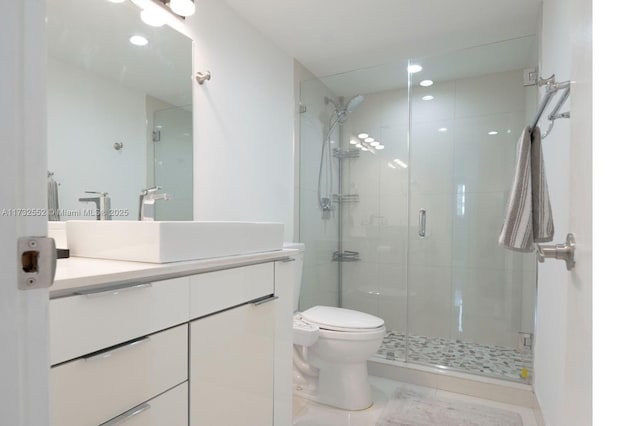 bathroom featuring vanity, tile patterned floors, toilet, and walk in shower