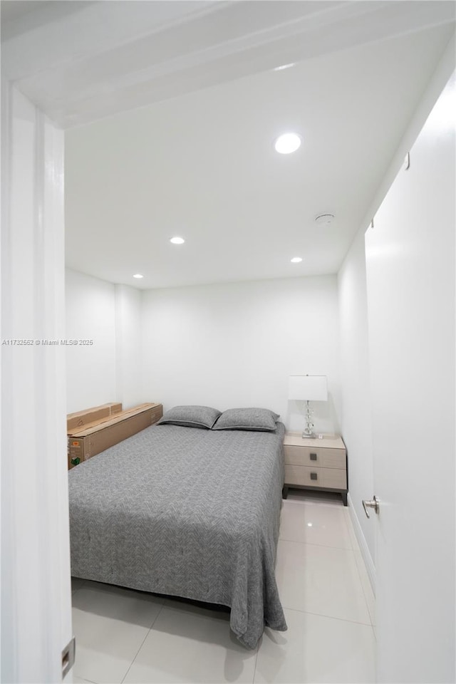 bedroom with light tile patterned floors