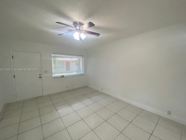 empty room with a textured ceiling and ceiling fan