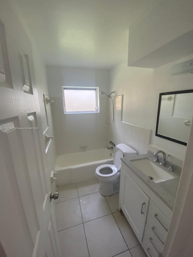 full bathroom with vanity, tile patterned floors, toilet, and shower / washtub combination