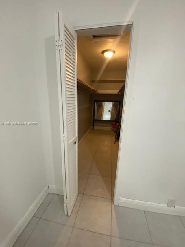 corridor with light tile patterned floors