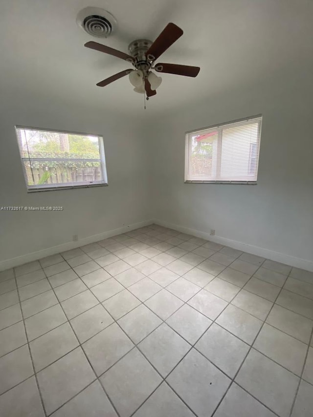 unfurnished room with light tile patterned floors and ceiling fan