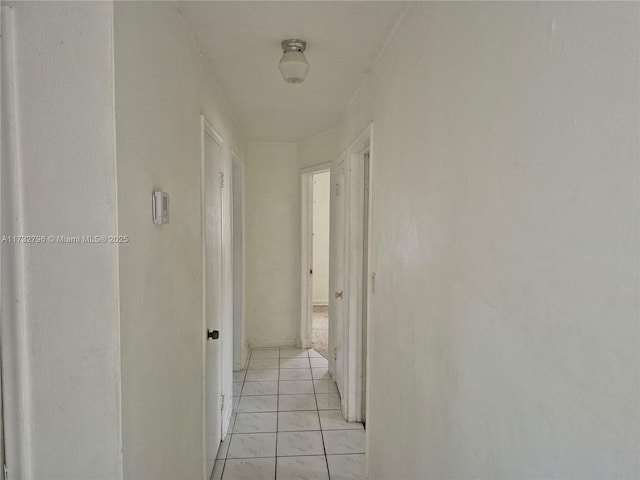 corridor featuring light tile patterned floors