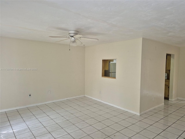 unfurnished room featuring ceiling fan and light tile patterned floors