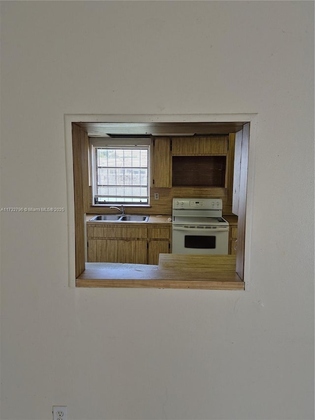 kitchen featuring sink and electric range