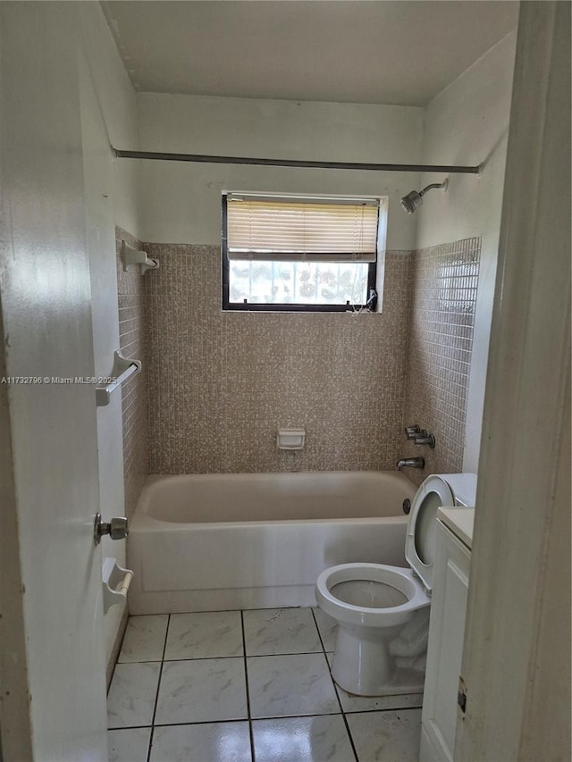 full bathroom with tiled shower / bath, vanity, toilet, and tile patterned flooring