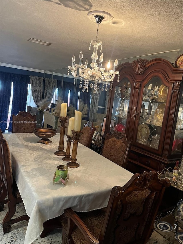 dining room featuring a textured ceiling and a notable chandelier