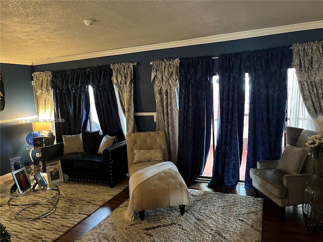 sitting room with dark hardwood / wood-style flooring, a healthy amount of sunlight, crown molding, and a textured ceiling