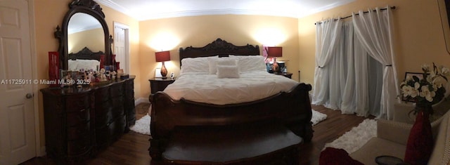 bedroom featuring ornamental molding and dark hardwood / wood-style floors