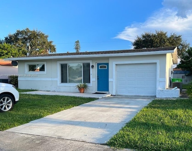 single story home featuring a garage and a front lawn