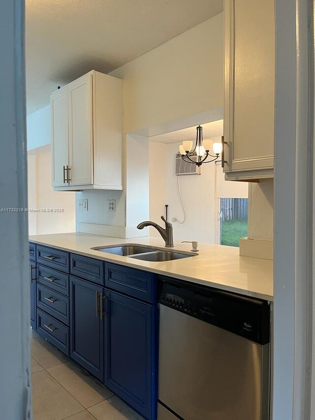 kitchen featuring pendant lighting, sink, dishwasher, white cabinetry, and light tile patterned flooring