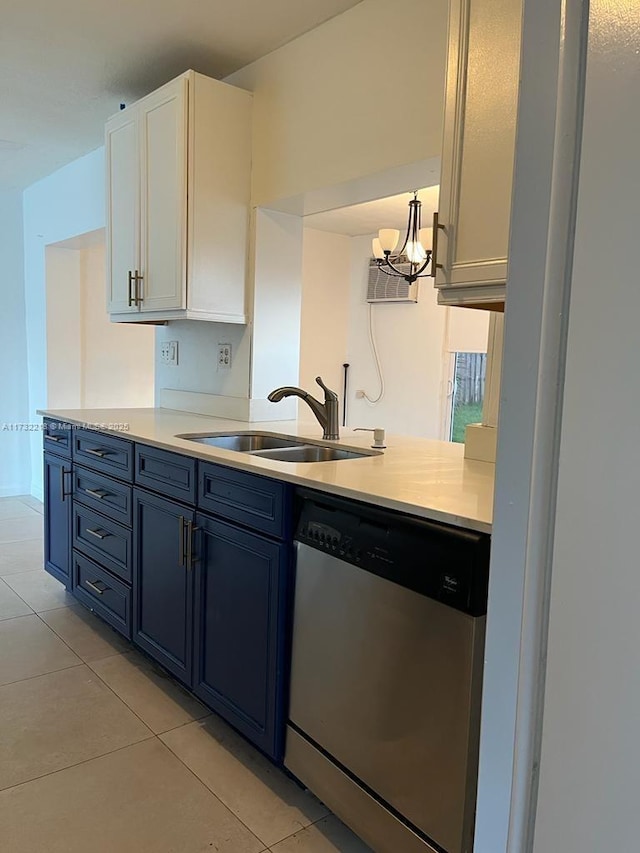 kitchen featuring light tile patterned flooring, sink, decorative light fixtures, dishwasher, and white cabinets