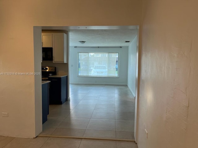 corridor featuring light tile patterned flooring