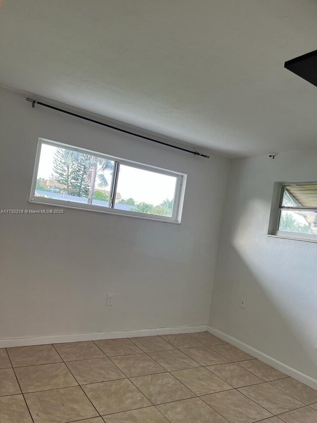 spare room with light tile patterned floors