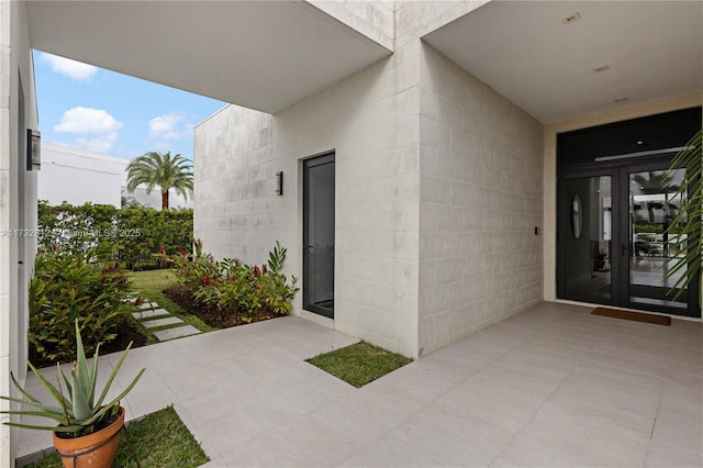 view of exterior entry featuring french doors