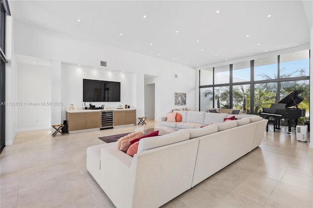 living room featuring expansive windows, bar area, and wine cooler