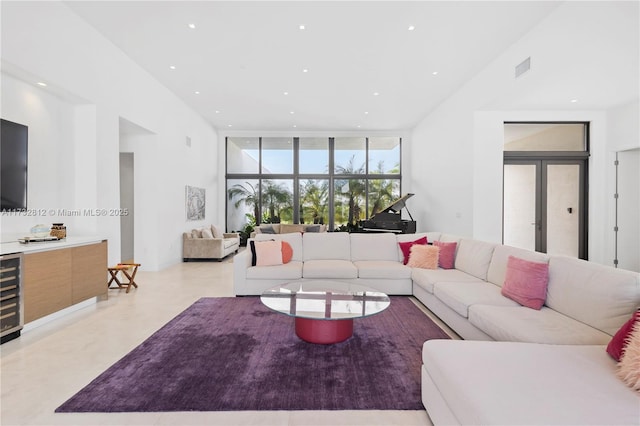 living room with a wall of windows and french doors