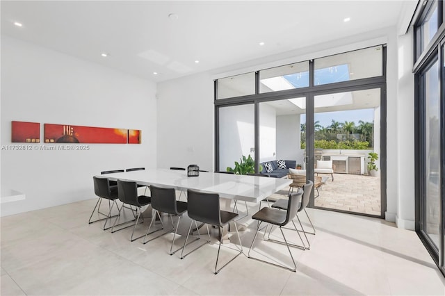 dining space featuring a wall of windows