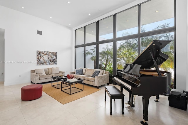 misc room with expansive windows, a towering ceiling, and light tile patterned floors