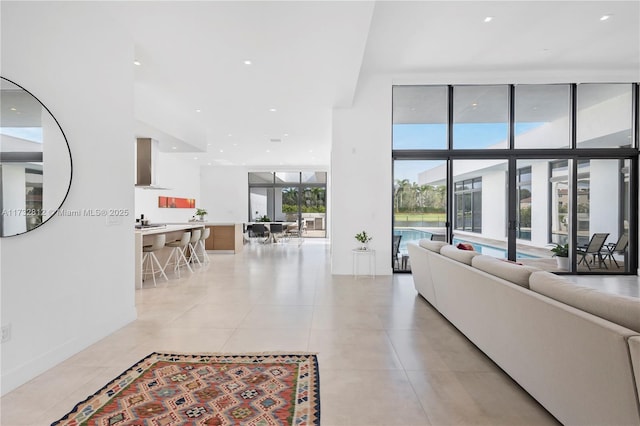 living room featuring floor to ceiling windows and light tile patterned flooring