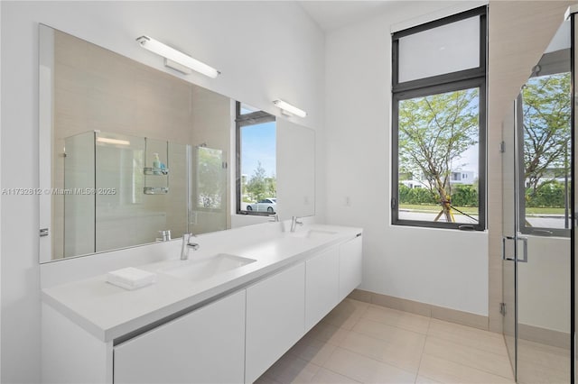 bathroom with vanity, tile patterned floors, and a shower with door