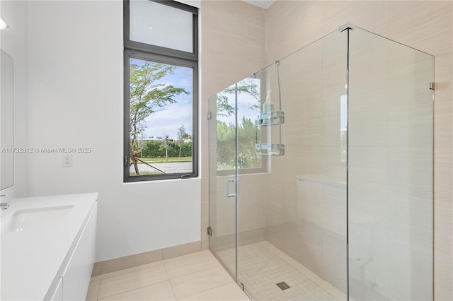 bathroom with walk in shower, tile patterned floors, and vanity